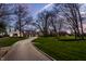 Exterior home view that features a long driveway and well-manicured lawn at 1995 W 116Th St, Carmel, IN 46032