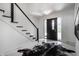 This light foyer features an open staircase and elegant marble flooring that creates a welcoming entrance at 1995 W 116Th St, Carmel, IN 46032