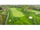 Aerial view highlighting the pristine golf course with its expansive greens, bunkers, and meticulously maintained grounds at 1995 W 116Th St, Carmel, IN 46032