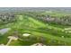 Scenic aerial view of the golf course with lush green fairways and manicured sand traps in a verdant, residential area at 1995 W 116Th St, Carmel, IN 46032