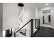 Stairwell hallway featuring modern chandelier and a view to the entry way at 1995 W 116Th St, Carmel, IN 46032