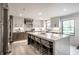 Open kitchen featuring a large island with seating, bright countertops, and stainless appliances at 1995 W 116Th St, Carmel, IN 46032