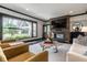 Inviting living room featuring a modern fireplace, large window, and stylish decor at 1995 W 116Th St, Carmel, IN 46032