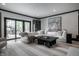 Bright living room featuring a large sectional sofa, modern art, and sliding glass doors to the outside patio at 1995 W 116Th St, Carmel, IN 46032
