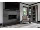 Modern living room with a fireplace, TV, and comfortable armchair, creating a cozy and stylish space at 1995 W 116Th St, Carmel, IN 46032