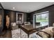 Sophisticated home office with dark walls, a spacious desk, and an outside view at 1995 W 116Th St, Carmel, IN 46032