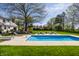 Backyard pool with paved pool deck and lounge seating provides a private outdoor living space at 1995 W 116Th St, Carmel, IN 46032