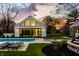 The poolhouse is equipped with expansive windows and modern design for luxurious poolside enjoyment at 1995 W 116Th St, Carmel, IN 46032