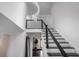 Modern staircase with black handrails and a unique light fixture at 1995 W 116Th St, Carmel, IN 46032