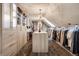 A well-lit walk-in closet with ample storage, custom cabinets and central island at 1995 W 116Th St, Carmel, IN 46032