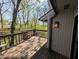 Inviting balcony with wood floors, a small table and chairs, and serene wooded views at 21 Osage Ct, Columbus, IN 47201