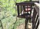 Elevated balcony surrounded by dense greenery, offering a private retreat at 21 Osage Ct, Columbus, IN 47201