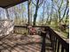 Relaxing balcony featuring wooden floors, patio seating, and views of lush greenery at 21 Osage Ct, Columbus, IN 47201