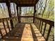 Wooden balcony with a view of the surrounding trees and neighborhood at 21 Osage Ct, Columbus, IN 47201