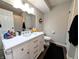 Bathroom with a white vanity, toilet, and a large mirror at 21 Osage Ct, Columbus, IN 47201