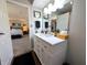 Bathroom featuring a white vanity, mirror, and an open doorway to the main bedroom at 21 Osage Ct, Columbus, IN 47201