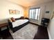 Bright bedroom featuring a daybed, fluffy rug, and a window at 21 Osage Ct, Columbus, IN 47201
