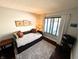 Bright bedroom featuring a daybed, plush rug, dark wood floors and ample natural light at 21 Osage Ct, Columbus, IN 47201