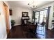 Bright dining room featuring hardwood floors, modern lighting, glass table, and sliding door to outdoor deck at 21 Osage Ct, Columbus, IN 47201