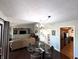 Bright dining room featuring dark wood floors, stylish lighting, and modern furniture at 21 Osage Ct, Columbus, IN 47201