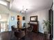 Cozy dining area with dark wood floors, a glass table, and a modern chandelier at 21 Osage Ct, Columbus, IN 47201