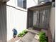 Covered home entrance with glass sliding doors, brick accents, and landscaping at 21 Osage Ct, Columbus, IN 47201