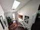 Well-lit foyer with skylight, decorative lighting, hardwood floors, staircase, and stylish entryway at 21 Osage Ct, Columbus, IN 47201