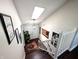 Bright foyer with skylight, hardwood floors, decorative rug, and access to the home's front door and staircase at 21 Osage Ct, Columbus, IN 47201