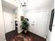 Welcoming foyer featuring dark wood floors, a modern light fixture, and a view into the home's interior spaces at 21 Osage Ct, Columbus, IN 47201