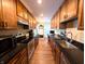 Updated kitchen featuring wooden cabinets, stainless steel appliances, granite countertops, and tile flooring at 21 Osage Ct, Columbus, IN 47201