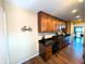 Open-concept kitchen with wood cabinets, a built-in workspace, dark countertops, and stainless steel sink at 21 Osage Ct, Columbus, IN 47201