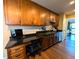 Well-equipped kitchen featuring wooden cabinets, dark counters, stainless steel sink and adjacent workspace at 21 Osage Ct, Columbus, IN 47201