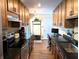 Updated kitchen with wooden cabinets, stainless steel appliances, granite countertops, and tile flooring at 21 Osage Ct, Columbus, IN 47201