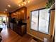 Modern kitchen with wood cabinets, dark countertops, stainless steel appliances, and bright natural light at 21 Osage Ct, Columbus, IN 47201