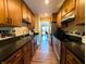Efficient kitchen design showcasing wooden cabinets, dark countertops, and stainless steel appliances at 21 Osage Ct, Columbus, IN 47201