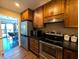 Well-appointed kitchen with wooden cabinets, black countertops, and stainless steel appliances at 21 Osage Ct, Columbus, IN 47201