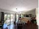 Open concept living room with a glass table, dark wood floors, and natural light at 21 Osage Ct, Columbus, IN 47201