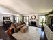 Open living room featuring a fireplace and a sliding glass door to the deck at 21 Osage Ct, Columbus, IN 47201