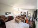 Spacious living room with a plush carpet, clerestory window, and staircase at 21 Osage Ct, Columbus, IN 47201