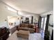 Open living room with a vaulted ceiling, sliding glass door, and a staircase at 21 Osage Ct, Columbus, IN 47201