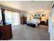 Bright main bedroom featuring a balcony, soft carpet, and decorative accents at 21 Osage Ct, Columbus, IN 47201