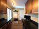 Well-organized mud room with dark counters, coat rack, shoe storage, and wood flooring for streamlined living at 21 Osage Ct, Columbus, IN 47201