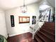 Beautiful wood staircase with white railings, showcasing decorative wall accents and elegant design elements throughout at 21 Osage Ct, Columbus, IN 47201