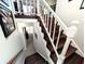 Staircase showcasing wooden steps and white railings, leading to upper and lower floors with views of the home's interior at 21 Osage Ct, Columbus, IN 47201