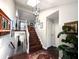 Inviting staircase with wood steps and white railings, connecting multiple levels with views of the home's interior spaces at 21 Osage Ct, Columbus, IN 47201