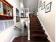 Elegant staircase with wooden steps and white railings, providing access to the upper floors and basement area at 21 Osage Ct, Columbus, IN 47201
