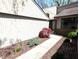 A walkway to the front entrance is lined with green bushes and a red tree at 21 Osage Ct, Columbus, IN 47201