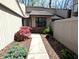 A walkway to the front entrance is lined with green bushes and a red tree at 21 Osage Ct, Columbus, IN 47201