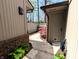 Walkway between homes with landscaping and a storage closet at 21 Osage Ct, Columbus, IN 47201