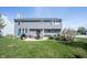 Large backyard with patio, fire pit, outdoor furniture, and well-manicured lawn at 2261 Mustang Chase Dr, Carmel, IN 46074